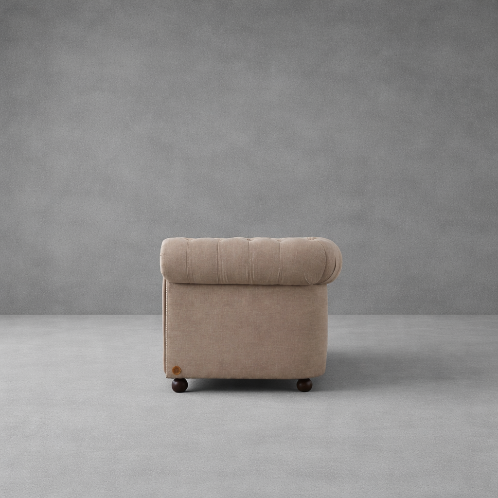 Side profile of Luxe Chesterfield velvet sofa showcasing elegant curved armrest design.