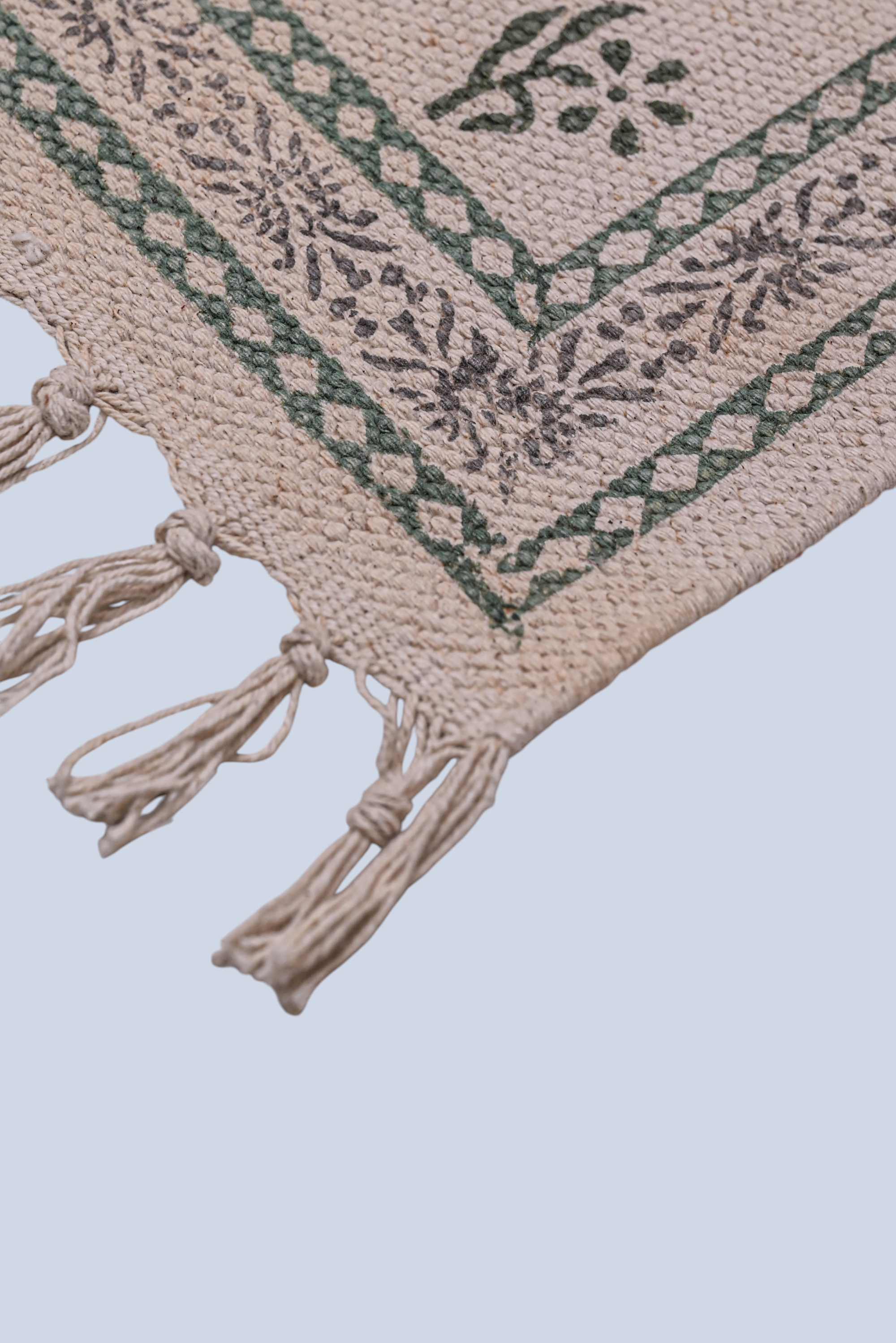 full view of minimal cotton runner rug with green dots pattern